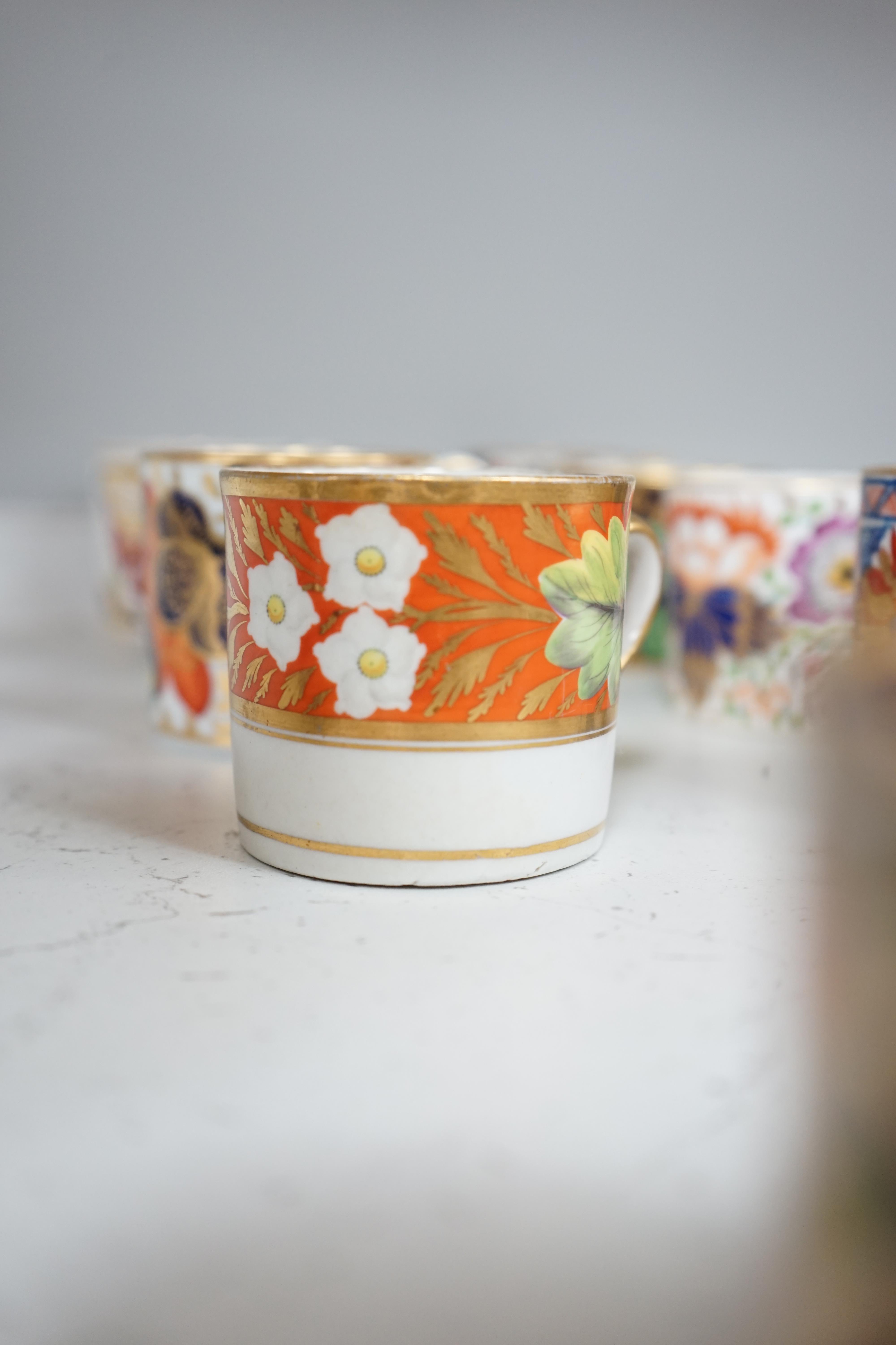 Twelve 1800-1820 English porcelain floral designed coffee cans